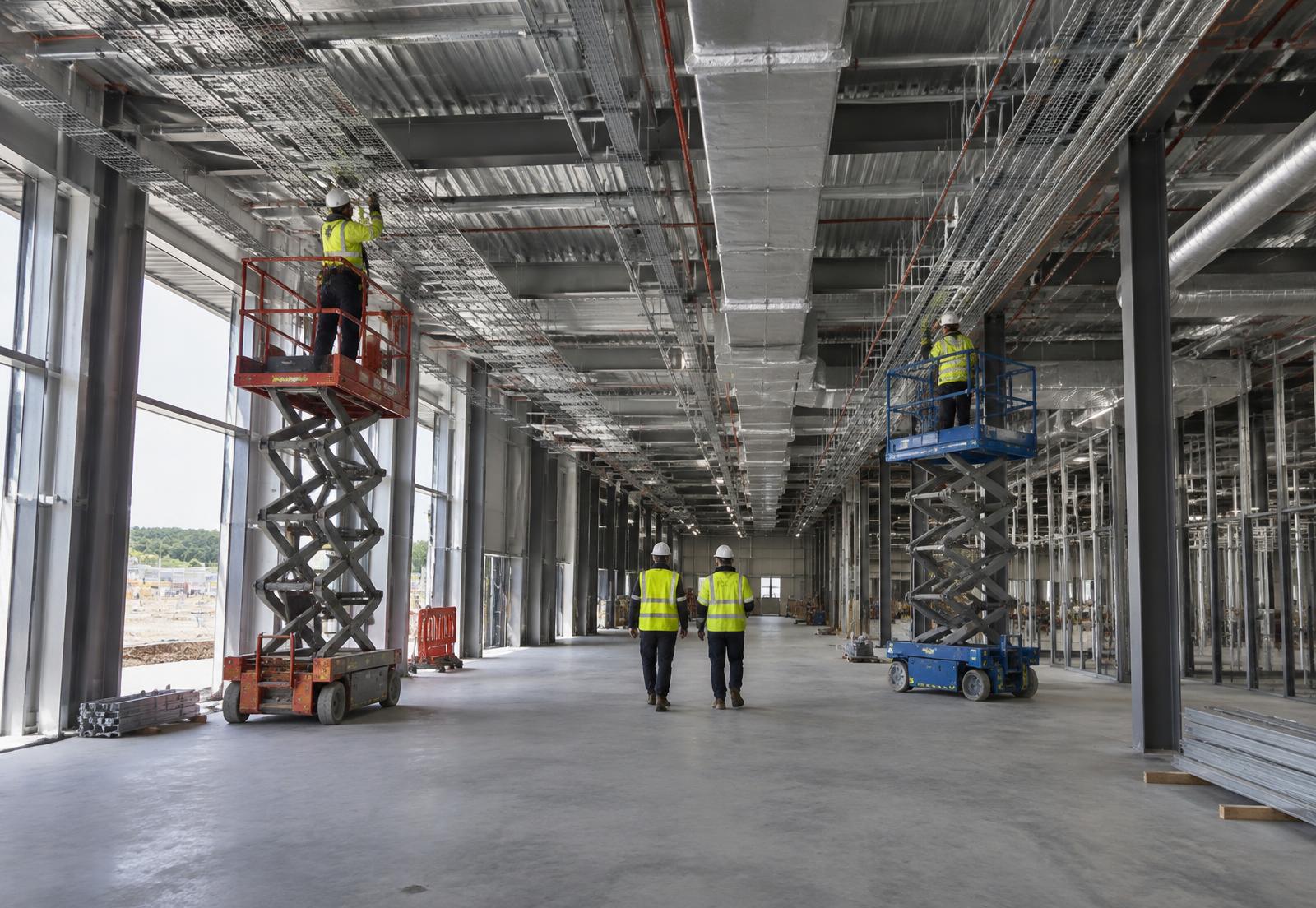 Infrastructure specialists installing services in a major data centre construction hall